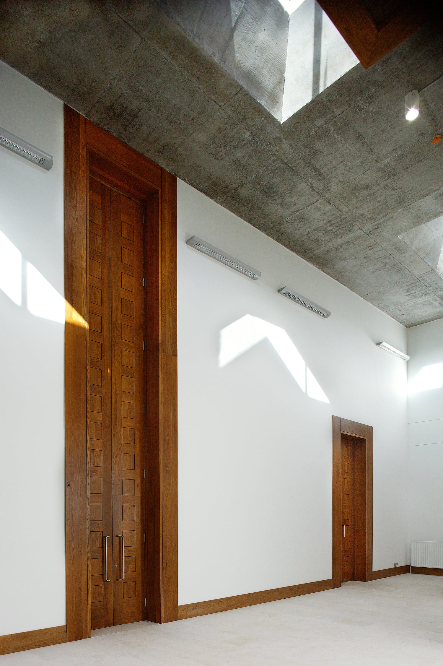6 Inside of munster technological university with wooden door and white wall.
